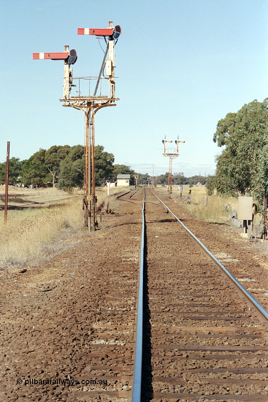 171-16
Buangor station yard overview, looking towards Melbourne, from up home semaphore signal Post 6, semaphore signal Post 5 facing down trains, signal box in the distance.

