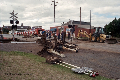 171-05
Ballarat, Linton Junction signal box Gillies St, work site view, interlocked gates being replaced by boom barriers, view of removed interlocked gate posts, boom barriers in position.
