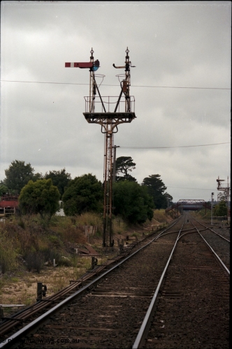 172-21
Ballarat East, semaphore signal post 4, looking east towards Warrenheip, point rodding and points, Queen Street bridge in the background, new electric colour light signal post also visible.
