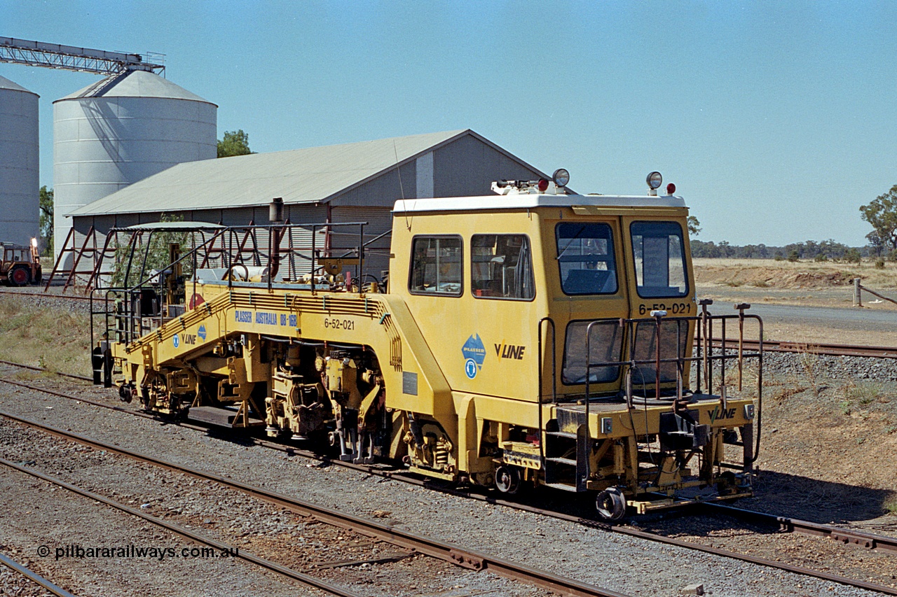 173-09
Murchison East, V/Line broad gauge track machine, asset no. 6-52-021, which is a Plasser 08-16B track tamper, silo complex and horizontal grain bin behind machine.
Keywords: Plasser;08-16B;6-52-021;track-machine;