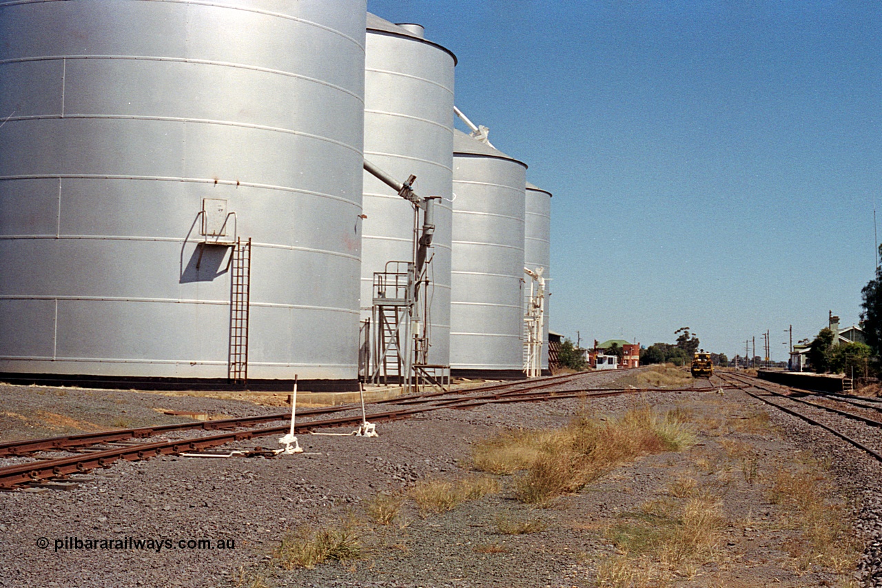 173-16
Murchison East, yard overview looking south, point levers, Ascom silo complex load-out spout with Murphy style silos and spout, Railway Hotel, track machines and the station platform and building.
