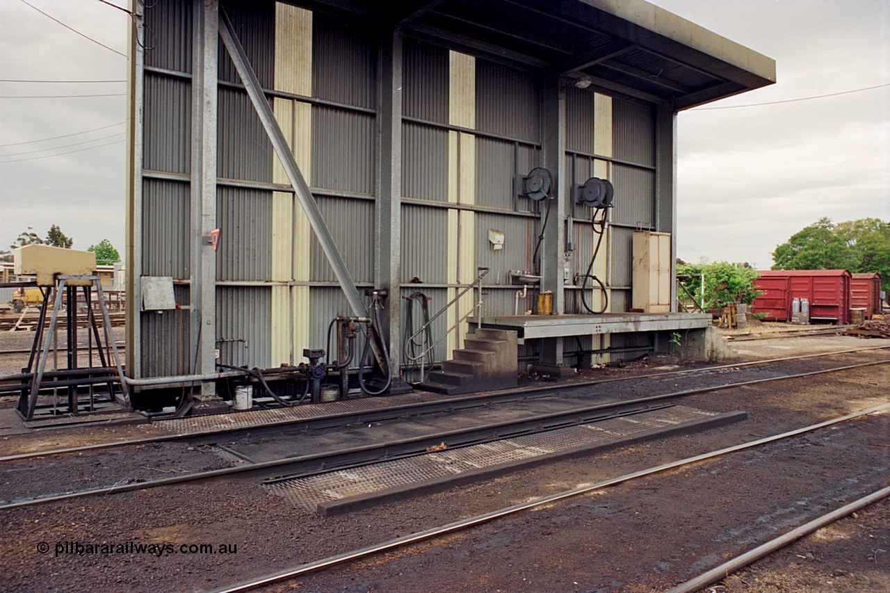 174-05
Wodonga, loco depot, fuel point canopy, showing fuel line and nozzle, hose reels etc. The grounded B vans in the background are for the examiners siding.
