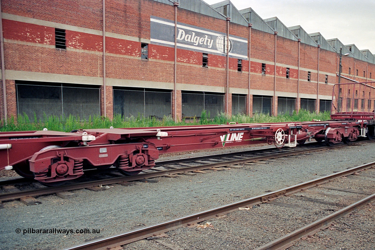 174-20
Albury, V/Line standard gauge VQAW type leader VQAW 1, three pack articulated container waggon with Gloucester bogies, built new at Ballarat North Workshops and issued to traffic 22-11-1990, empty on a south bound goods train, the disused Dalgety's warehouse is behind the waggon.
Keywords: VQAW-type;VQAW1;V/Line-Ballarat-Nth-WS;