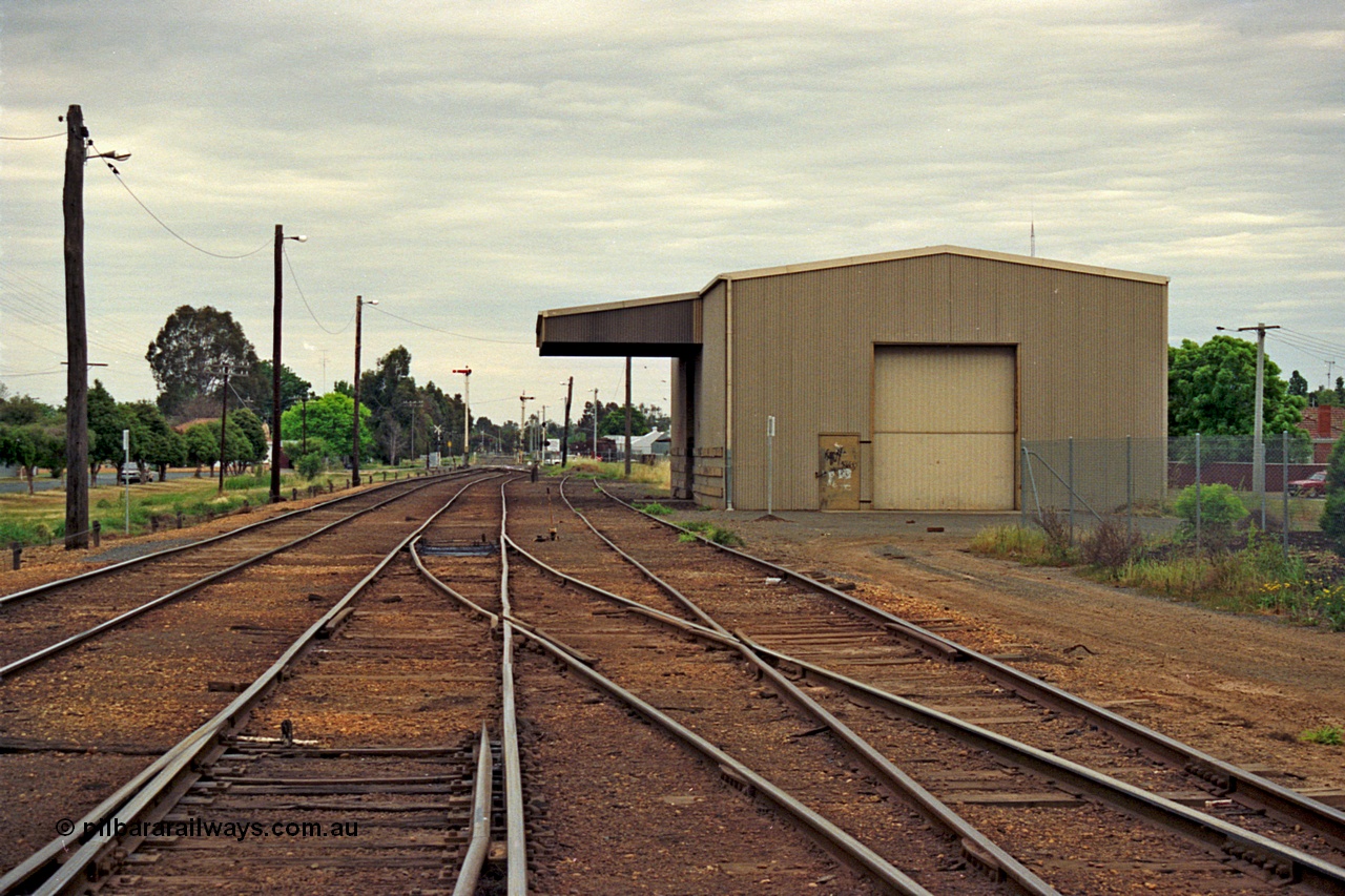 175-11
Shepparton yard overview looking south from the end of the yard, disused loading shed with canopy, up and down home semaphore signal post in the distance, roads are from left, No.1, No.2 or mainline, and an extension of No.3 Rd.

