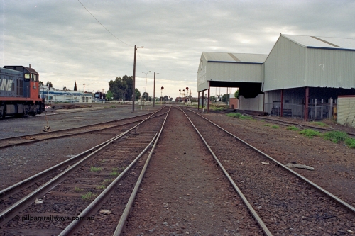 175-06
Shepparton station yard overview looking north, between No.1 and 2 roads, stabled V/Line broad gauge T class loco at left, lines heading north are the Tocumwal line, left, and the Dookie, former Katamatite, line on the right, on the far right is the former engine track, now disused J. Murray More Pty Ltd or Tubemakers Siding which had a 5 tonne unloading gantry under the awning.
