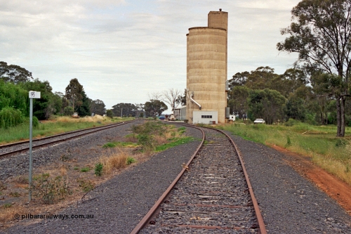175-20
Pine Lodge, yard overview looking towards Shepparton from the 195 km post, mainline on the left, site of former station and platform on the left, Williamstown style silo complex with super phosphate shed beyond it on the right.
