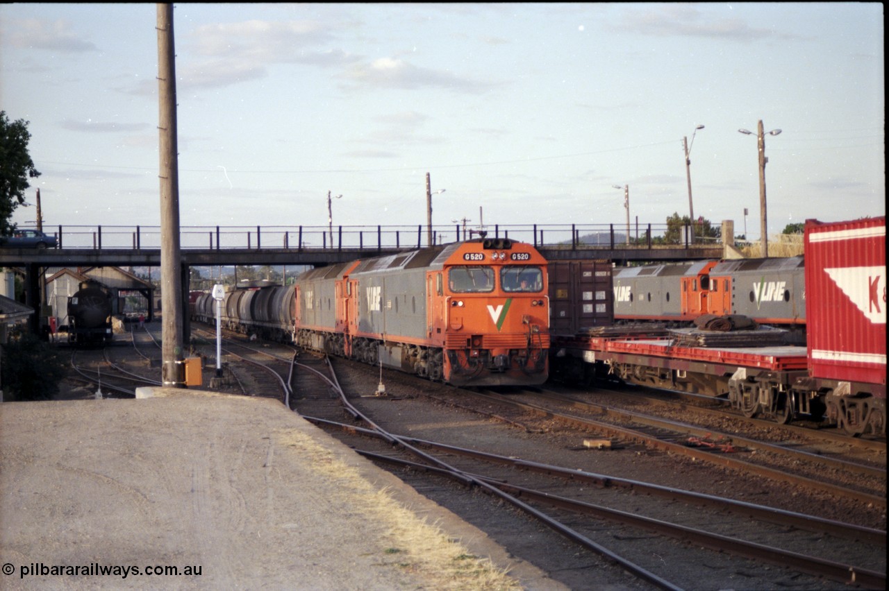 176-18
Albury, a pair of V/Line standard gauge G class units, lead by G 520 Clyde Engineering EMD model JT26C-2SS serial 85-1233 power an up goods train bound for Melbourne towards the platform and a crew change, the broad gauge diamond and track with a tank waggon are visible.
Keywords: G-class;G520;Clyde-Engineering-Rosewater-SA;EMD;JT26C-2SS;85-1233;