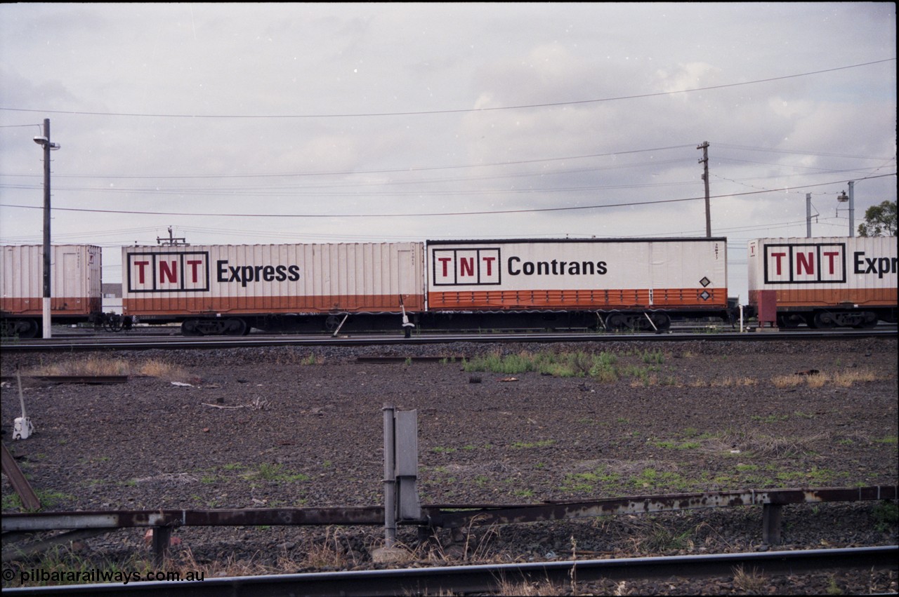 177-01
Tottenham Yard, side view of broad gauge Australian National AQDW type jumbo container waggon AQDW 4, loaded with two 2 TEU (two twenty foot equivalent unit) TNT containers, these waggons are 80 feet long.
Keywords: AQDW-type;AQDW4;