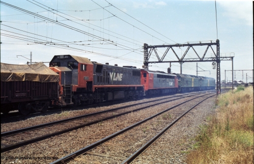 177-15
Newport, V/Line broad gauge down goods train to Adelaide 9169 with the impressive quad combo of a pair of Australian National BL class locomotives BL 27 Clyde Engineering EMD model JT26C-2SS serial 83-1011 and class leader BL 26 'Bob Hawke' serial 83-1010 and V/Line S class S 313 'Alfred Deakin' Clyde Engineering EMD model A7 serial 61-230 and V/Line X class loco X 53 with serial 75-800 a Clyde Engineering Rosewater SA built EMD model G26C round the curve on the Geelong line with the workshops in the background.
Keywords: X-class;X53;Clyde-Engineering-Rosewater-SA;EMD;G26C;75-800;