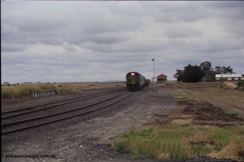 178-02
Cressy, the peace of this once former four way junction station is shattered as V/Line down broad gauge goods train 9169 to Adelaide powers past the station building along the crossing loop behind a quad of screaming EMD 2 stroke locomotives, an Australian National BL class is leading the charge.
