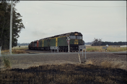 178-06
Lismore, down V/Line broad gauge goods train to Adelaide 9169 runs round the curve as it crosses Gnarpurt Road with the quad combo of a pair of Australian National BL class locomotives BL 27 Clyde Engineering EMD model JT26C-2SS serial 83-1011 and class leader BL 26 'Bob Hawke' serial 83-1010 and V/Line S class S 313 'Alfred Deakin' Clyde Engineering EMD model A7 serial 61-230 and X class X 53 Clyde Engineering EMD model G26C serial 75-800, BL 27 had Paul Keating drawn on the LHS cab as it was just after he'd taken the Labor Party leadership and the Prime Ministership off Bob Hawke.
Keywords: BL-class;BL27;Clyde-Engineering-Rosewater-SA;EMD;JT26C-2SS;83-1011;