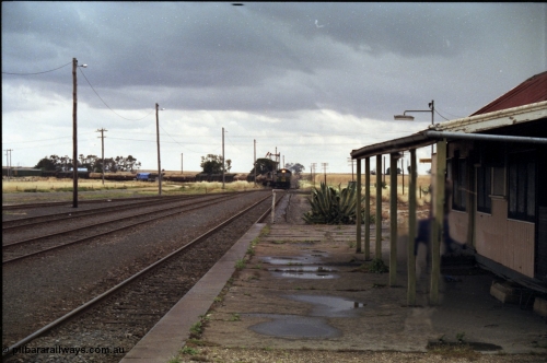 178-12
Maroona, station yard overview looking towards Portland from the platform as V/Line's down Adelaide goods train 9169 swings off the Cressy line behind with the quad combo of a pair of Australian National BL class locomotives BL 27 Clyde Engineering EMD model JT26C-2SS serial 83-1011 and class leader BL 26 'Bob Hawke' serial 83-1010 and V/Line S class S 313 'Alfred Deakin' Clyde Engineering EMD model A7 serial 61-230 and X class X 53 Clyde Engineering EMD model G26C serial 75-800.
