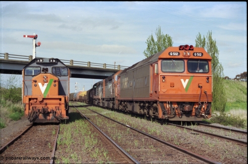 179-24
Gheringhap, V/Line broad gauge goods train 9169 to Adelaide behind G class G 512 Clyde Engineering EMD model JT26C-2SS serial 84-1240 and C classes C 510 Clyde Engineering EMD model GT26C serial 76-833 and C 509 serial 76-832 creeps along the Maroona Line under the Midland Highway overpass as the 2nd person has just climbed aboard G 512 and head home to Dimboola, X class X 51 Clyde Engineering EMD model G26C serial 75-798 is stowed in Siding C and the Ballarat Line is in-between the loco and train.
Keywords: G-class;G512;Clyde-Engineering-Rosewater-SA;EMD;JT26C-2SS;84-1240;