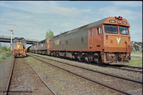 179-25
Gheringhap, V/Line broad gauge goods train 9169 to Adelaide behind G class G 512 Clyde Engineering EMD model JT26C-2SS serial 84-1240 and C classes C 510 Clyde Engineering EMD model GT26C serial 76-833 and C 509 serial 76-832 powers away on the Maroona Line bound for Dimboola and Adelaide, while X class X 51 Clyde Engineering EMD model G26C serial 75-798 is stowed in Siding C, the Ballarat Line is in-between the loco and train.
Keywords: G-class;G512;Clyde-Engineering-Rosewater-SA;EMD;JT26C-2SS;84-1240;