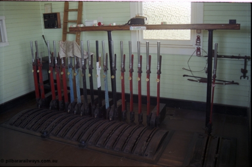 179-31
Gheringhap, internal view of signal box showing the new from 1907 18 lever frame, installed following the removal of double line block to Bannockburn, 2 lever frame extension on the right installed from 1918, lever 11 is painted white, blocked and abolished from 1977. Similarly lever 3 have been removed, most likely when the Maroona line distant was converted to a home signal and signal post 6 was abolished in 1990.
