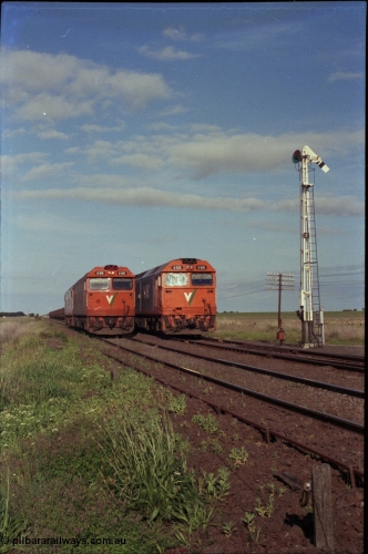 179-34
Gheringhap, track view looking east towards Geelong as broad gauge V/Line light engines G class G 515 Clyde Engineering EMD model JT26C-2SS serial 85-1243 and a sister arrive from North Geelong to recover X 51 pass fellow G class G 521 Clyde Engineering EMD model JT26C-2SS serial 85-1234 locked away with down empty grain train 9121 in Siding A.
Keywords: G-class;G515;Clyde-Engineering-Rosewater-SA;EMD;JT26C-2SS;85-1243;