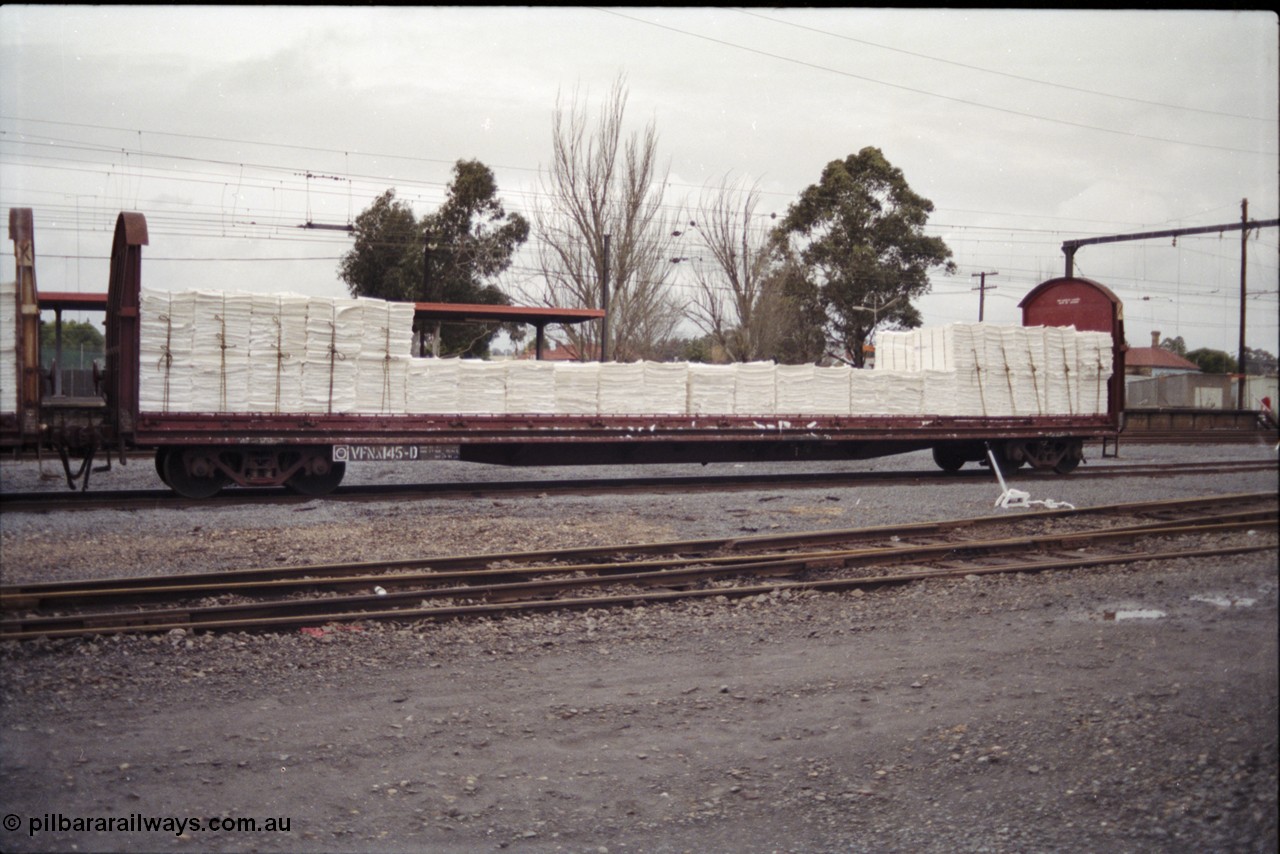 181-24
Traralgon yard, broad gauge V/Line VFNX type bogie roll paper waggon VFNX 145 hand brake end with tarpaulin and supports removed, originally built new May 1979 by Victorian Railways Newport Workshops as VFNX 45, but renumbered in the 100 series when the tarpaulin supports were removed in the 1990s.
Keywords: VFNX-type;VFNX145;Victorian-Railways-Newport-WS;VFNX45;