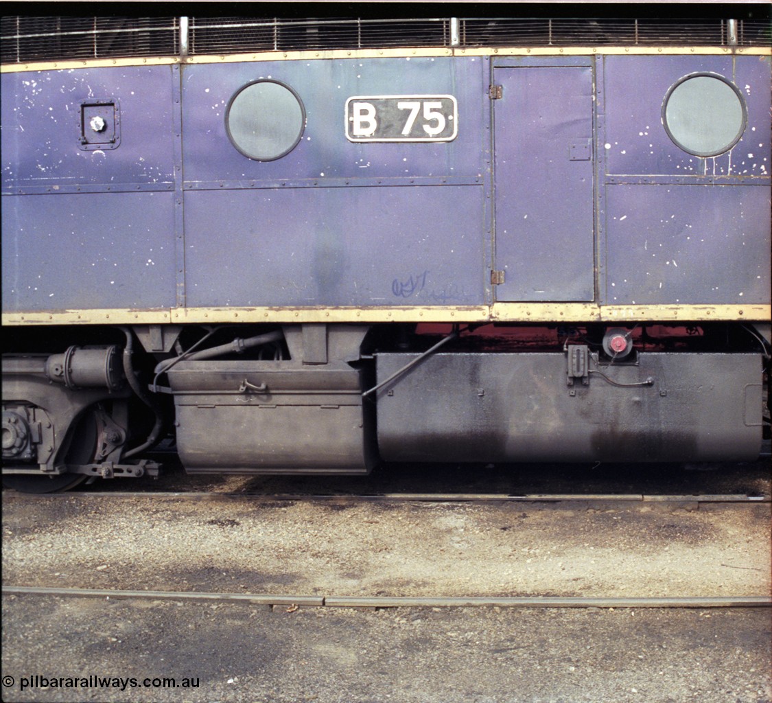 183-26
Wodonga loco depot fuel point, V/Line broad gauge Bulldog B class locomotive B 75 Clyde Engineering EMD model ML2 serial ML2-16 still in Victorian Railways livery, side view of battery box and fuel tank.
Keywords: B-class;B75;Clyde-Engineering-Granville-NSW;EMD;ML2;ML2-16;bulldog;