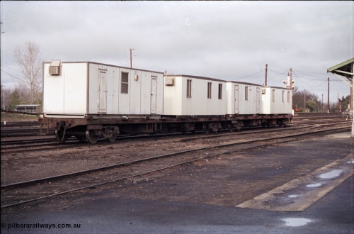 183-16
Benalla, yard view, V/Line broad gauge VQCX type 60 foot bogie container waggons VQCX 968 which was built new by Victorian Railways Ballarat North Workshops in April 1980 and another loaded with workman's dongers, or accommodation blocks, the yard is being rationalised.
Keywords: VQCX-type;VQCX968;Victorian-Railways-Ballarat-Nth-WS;