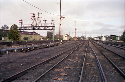 183-18
Benalla station yard overview with removed rails and partially stripped signal gantry as the yard goes about being rationalised, waggon workshops visible at left, along with B Signal Box, station building, A Signal Box in the distance, goods shed and Freight Gate canopy.

