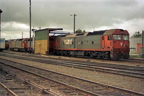 184-01
Albury loco depot fuel point, V/Line standard gauge locos lined up awaiting the Sunday run of goods trains back to Melbourne, G class G 527 Clyde Engineering EMD model JT26C-2SS serial 88-1257, C class C 503 Clyde Engineering EMD model GT26C serial 76-826 and G classes G 520 serial 85-1233 and partly obscured G 525 serial 86-1238, semaphore signal and rear of fuel point, view across yard, point rodding.
Keywords: G-class;G527;Clyde-Engineering-Somerton-Victoria;EMD;JT26C-2SS;88-1257;C-class;C503;GT26C;76-826;G520;85-1233;G525;86-1238;