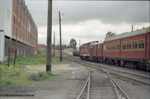 184-03
Albury station yard, standard gauge NSWSRA 81 class 8161 Clyde Engineering EMD model JT26C-2SS serial 84-1080 in candy livery leads a special 'Phantom of the Opera' passenger train bound for Sydney, trailing view, the old Dalgety's building is at left.
Keywords: 81-class;8161;Clyde-Engineering-Kelso-NSW;EMD;JT26C-2SS;84-1080;