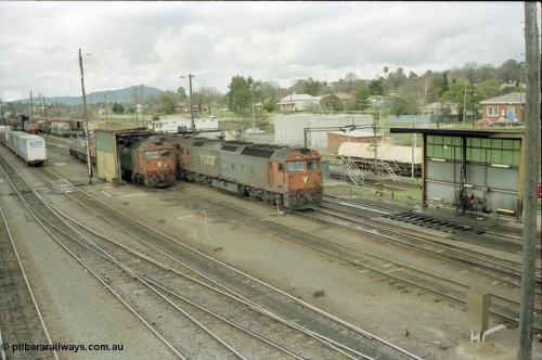 184-21
Albury station yard overview, loco depot, V/Line standard gauge G class G 527 Clyde Engineering EMD model JT26C-2SS serial 88-1257 takes on water at the fuel point with C class behind it while G class G 520 serial 85-1233 leading sister G 525 serial 86-1238 shunts past light engine, elevated view of logo depot and fuel points.
Keywords: G-class;G527;Clyde-Engineering-Somerton-Victoria;EMD;JT26C-2SS;88-1257;C-class;G520;85-1233;G525;86-1238;