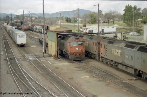 184-22
Albury station yard overview, loco depot, V/Line standard gauge G class G 527 Clyde Engineering EMD model JT26C-2SS serial 88-1257 takes on water at the fuel point with C class behind it while G class G 520 serial 85-1233 leading sister G 525 serial 86-1238 shunts past light engine, elevated view of loco depot and fuel point.
Keywords: G-class;G527;Clyde-Engineering-Somerton-Victoria;EMD;JT26C-2SS;88-1257;C-class;G520;85-1233;G525;86-1238;