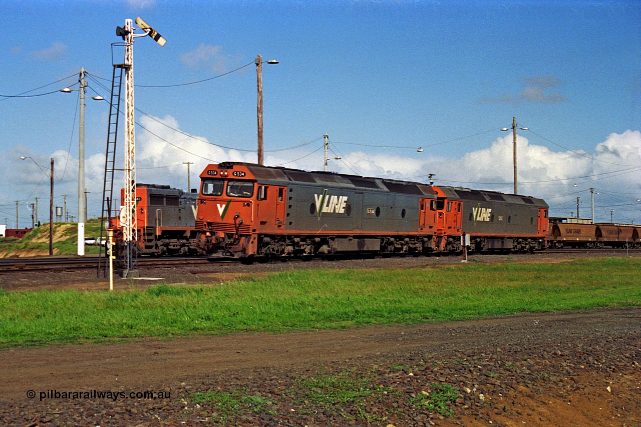 185-13
North Geelong Yard, V/Line light engines, G classes G 534 Clyde Engineering EMD model JT26C-2SS serial 88-1264 leads older sister and class leader G 511 serial 84-1239 as they run from North Geelong B Box past semaphore signal post 17 before shunting back into the sorting roads.
Keywords: G-class;G534;Clyde-Engineering-Somerton-Victoria;EMD;JT26C-2SS;88-1264;