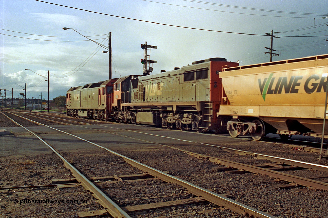 185-26
North Geelong C Box, Separation Street grade crossing, empty grain train behind G class G 528 Clyde Engineering EMD model JT26C-2SS serial 88-1258 and X class X 41 Clyde Engineering EMD model G26C serial 70-704 pass semaphore signal post 14 as they shunt up the mainline prior to setting back into the yard.
Keywords: X-class;X41;Clyde-Engineering-Granville-NSW;EMD;G26C;70-704;