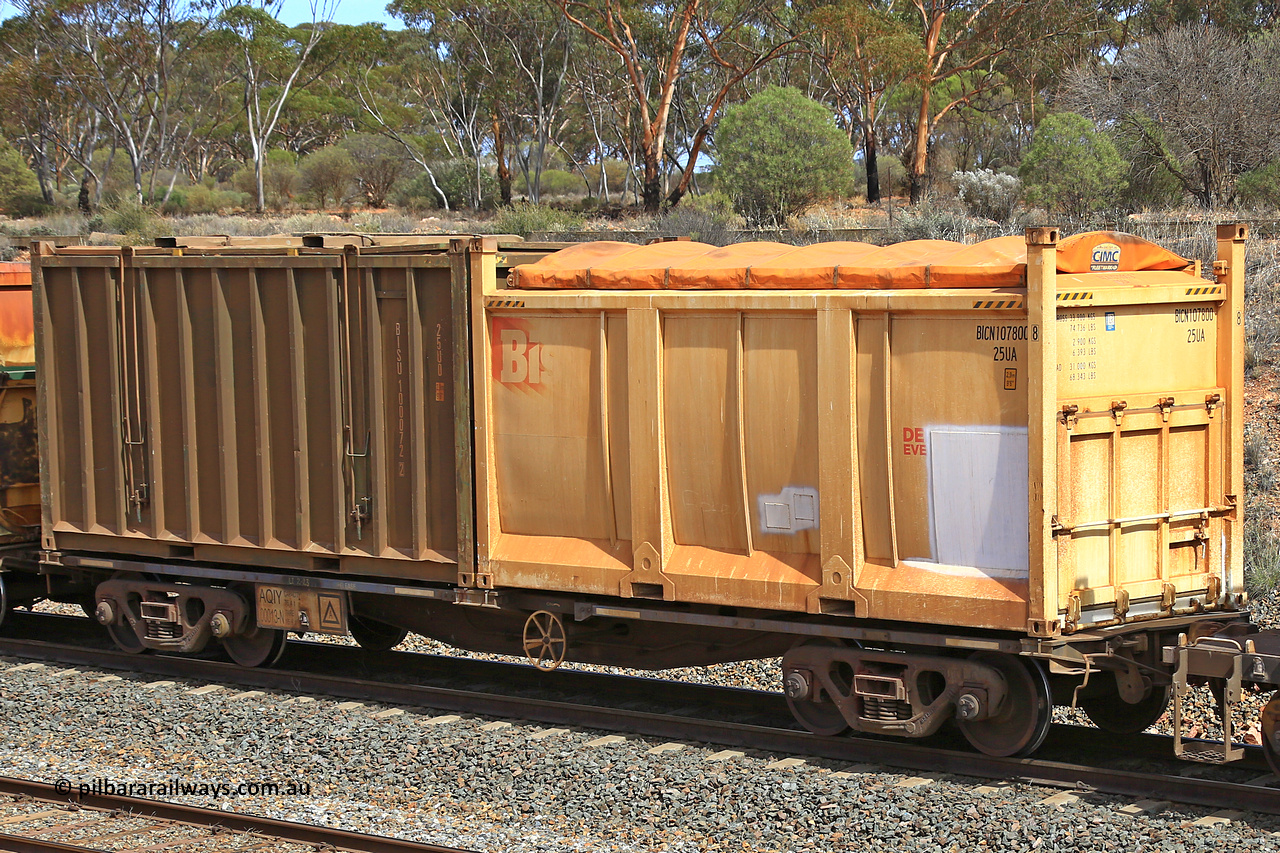 231020 8274
Binduli, 5029 Malcolm Freighter, AQIY type 40' container waggon AQIY 00013 with a Bis Deliver Every Day 25UA type roll-top sulphur container BICN 107800 and an undecorated Bis Industries hard-top 25U0 type sulphur containers BISU 100072. The AQIY started life built by Bradken and coded CQYY but CFCLA never bought them, so Bradken coded them KQYY and stored them. When Aurizon bought them they had the handbrake relocated to the middle of the waggon from the end.
Keywords: AQIY-type;AQIY00013;Bradken;CQYY-type;KQYY-type;