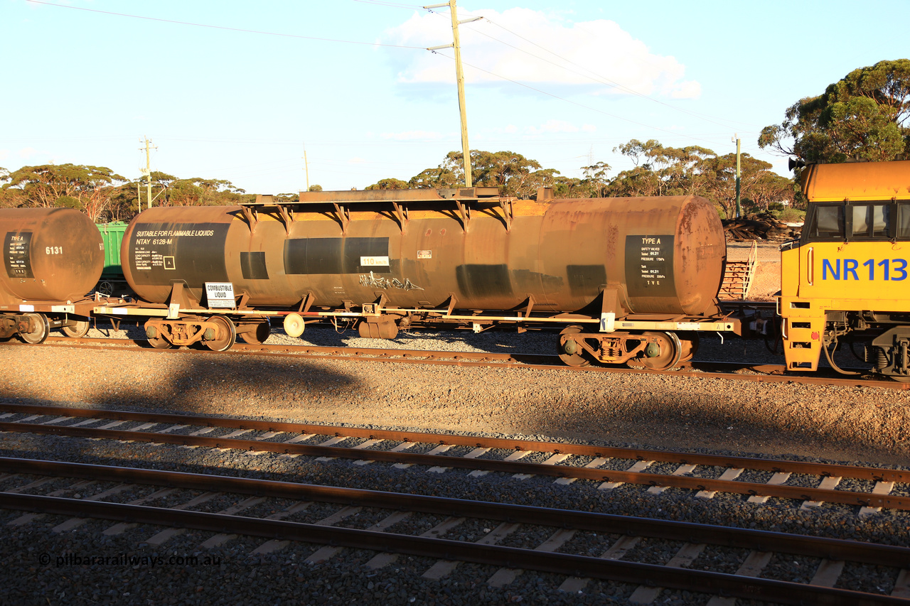 240328 3169
West Kalgoorlie, Viva Energy's NTAY 6128 fuel tank waggon, built by Indeng Qld in 1976 as SCA 279 for Shell, ex NTAF 279-6128, capacity of 61300 litres, fitted with conventional couplers, on Pacific National's train 5445 empty fuel to Esperance. March 28, 2024.
Keywords: NTAY-type;NTAY6128;Indeng-Qld;SCA-type;SCA279;NTAF-type;