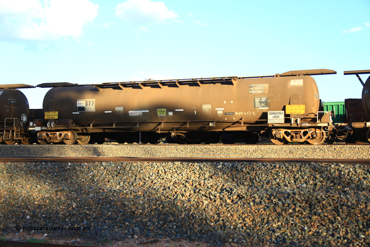 240328 3193
West Kalgoorlie, Viva Energy's APTF type fuel tank waggon ATPF 573 built by WAGR Midland Workshops in 1974 for Shell, in a batch of nine, as a WJP type 80,660 litre, one compartment one dome tank waggon, with a SFL of 80,500 litres, fitted with type F InterLock couplers. Pacific National empty fuel train 5445 to Esperance. March 28, 2024.
Keywords: ATPF-type;ATPF573;WAGR-Midland-WS;WJP-type;