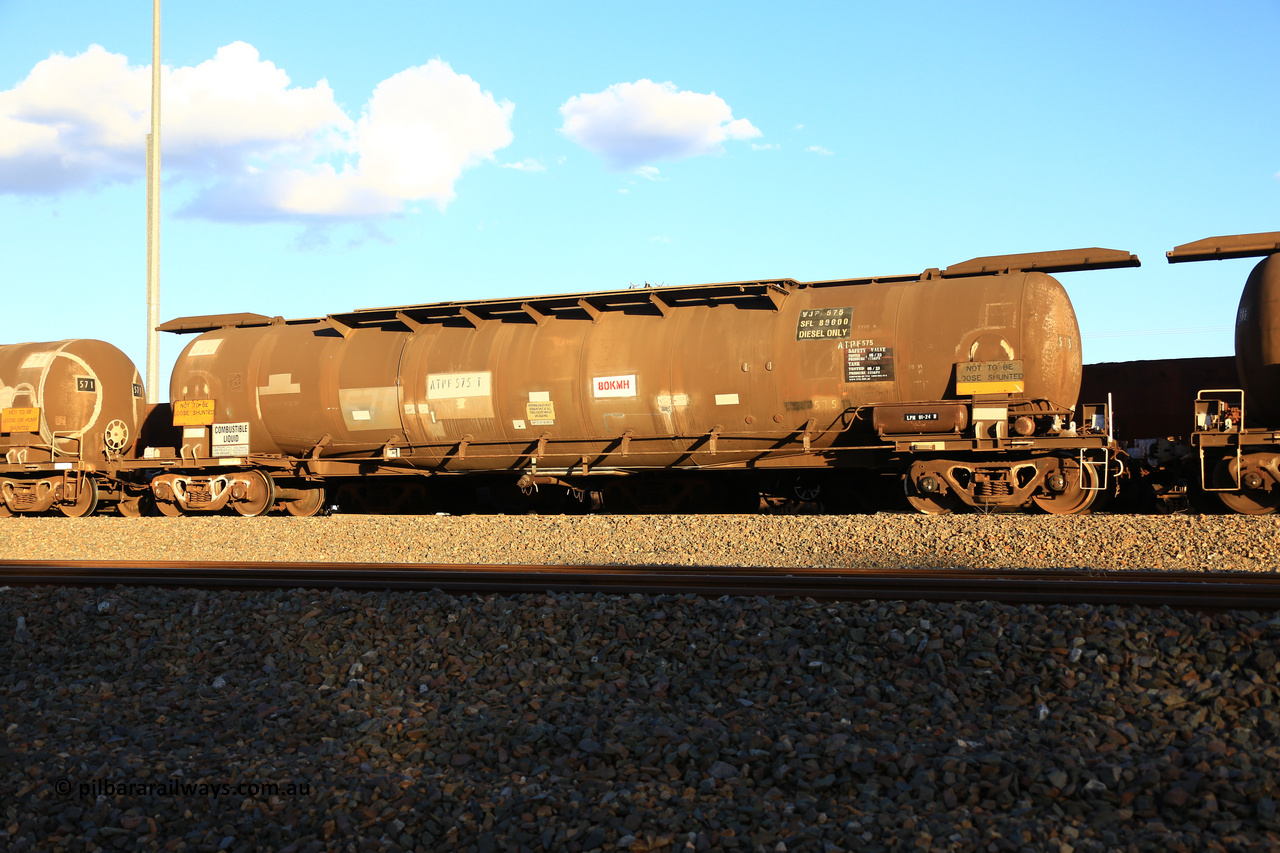 240328 3195
West Kalgoorlie, Viva Energy's APTF type fuel tank waggon ATPF 575 built by WAGR Midland Workshops in 1974 for Shell, in a batch of nine, as a WJP type 80,660 litre, one compartment one dome tank waggon, with a SFL of 80,500 litres, fitted with type F InterLock couplers. Pacific National empty fuel train 5445 to Esperance. March 28, 2024.
Keywords: ATPF-type;ATPF575;WAGR-Midland-WS;WJP-type;