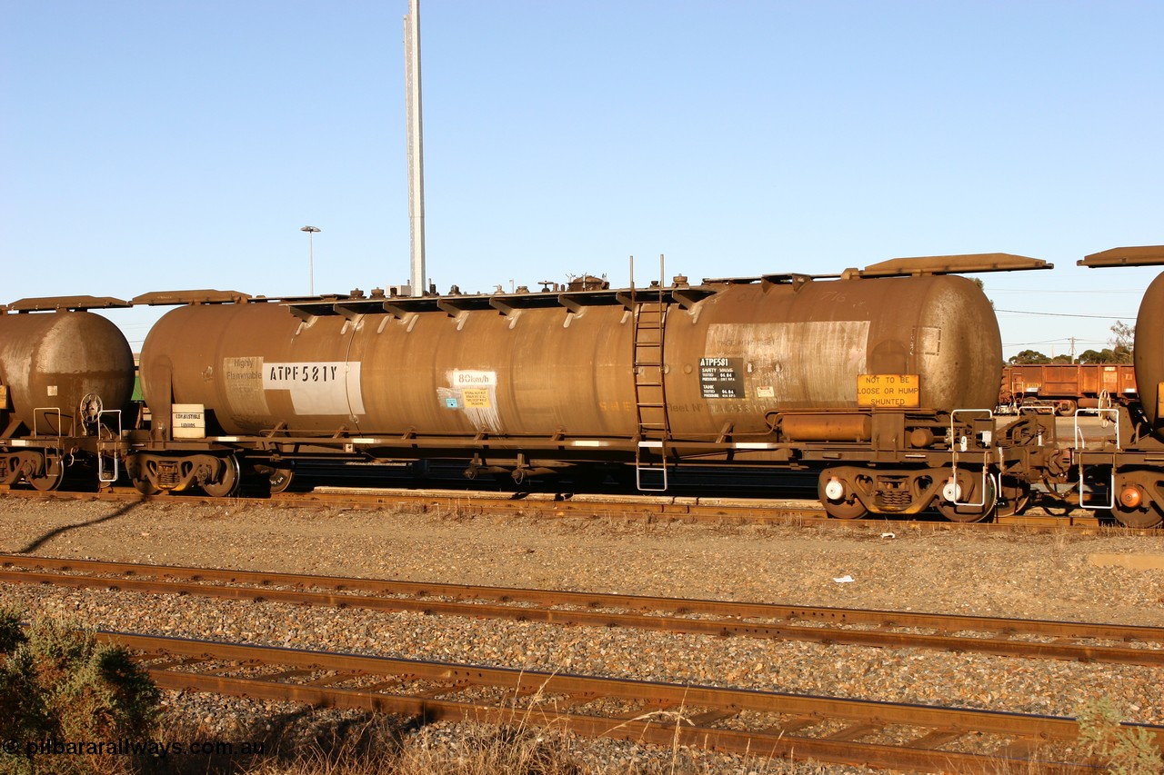 060528 4649 ATPF581Y
West Kalgoorlie, ATPF 581 fuel tank waggon built by WAGR Midland Workshops 1976 for Shell as type WJP 80.66 kL one compartment one dome, fitted with type F InterLock couplers.
Keywords: ATPF-type;ATPF581;WAGR-Midland-WS;WJP-type;JPC-type;