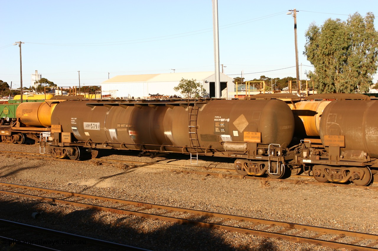 060528 4664
West Kalgoorlie, ATPF 579 fuel tank waggon built by WAGR Midland Workshops 1974 for Shell as WJP type 80.66 kL one compartment one dome, fitted with type F InterLock couplers.
Keywords: ATPF-type;ATPF579;WAGR-Midland-WS;WJP-type;