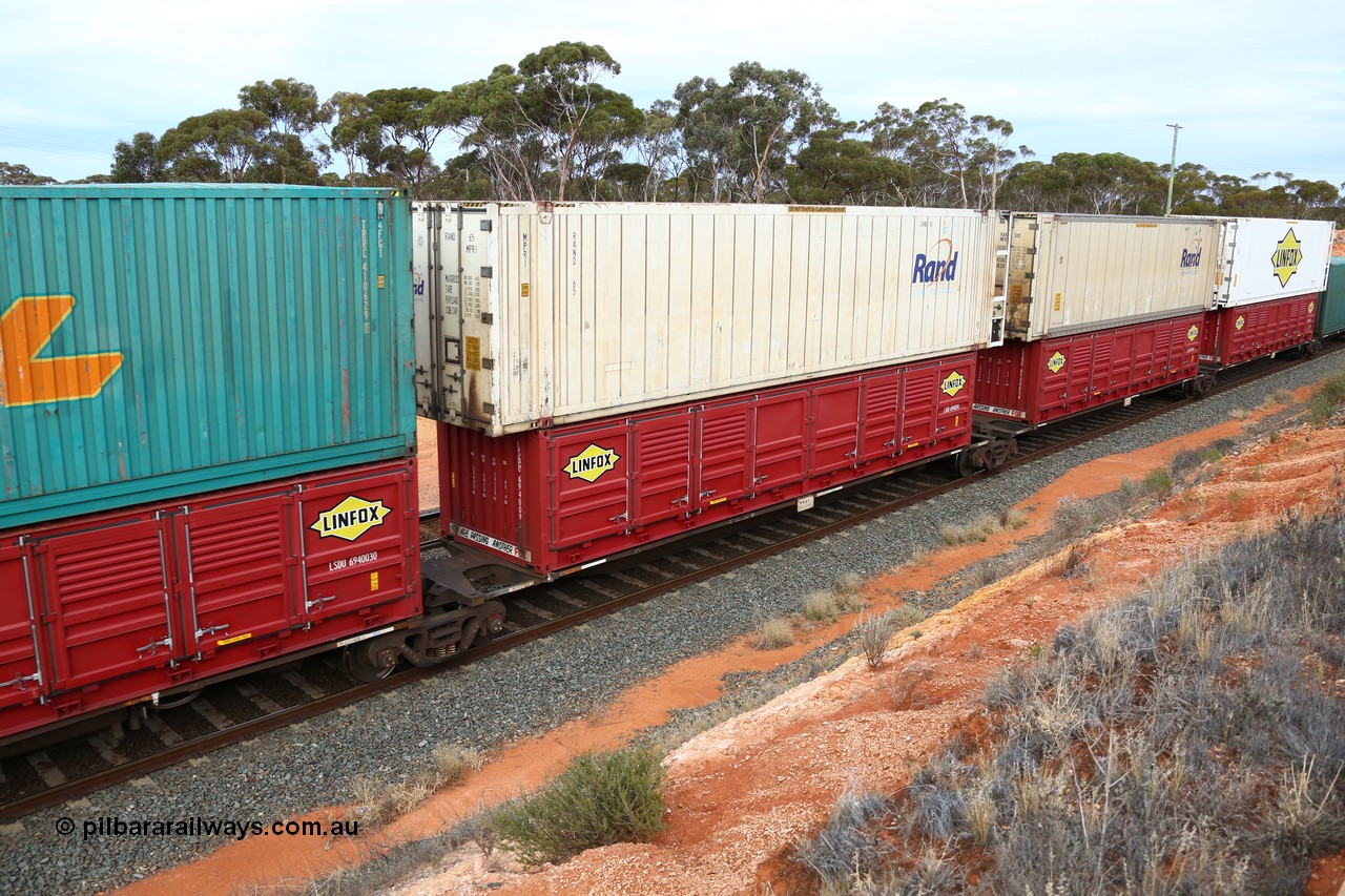 160524 3796
West Kalgoorlie, 2PM6 intermodal train, RRGY 7125 platform 2 of 5-pack articulated skeletal waggon set, one of fifty originally built by AN Rail Islington Workshops in 1996-97 as type RRBY, later rebuilt with 48' intermediate decks and recoded to RRGY, with a Linfox 40' half height side door LSDU 6940090 double stacked with a RAND Refrigerated Logistics 46' MPR1 type reefer RAND 65.
Keywords: RRGY-type;RRGY7125;AN-Islington-WS;RRBY-type;