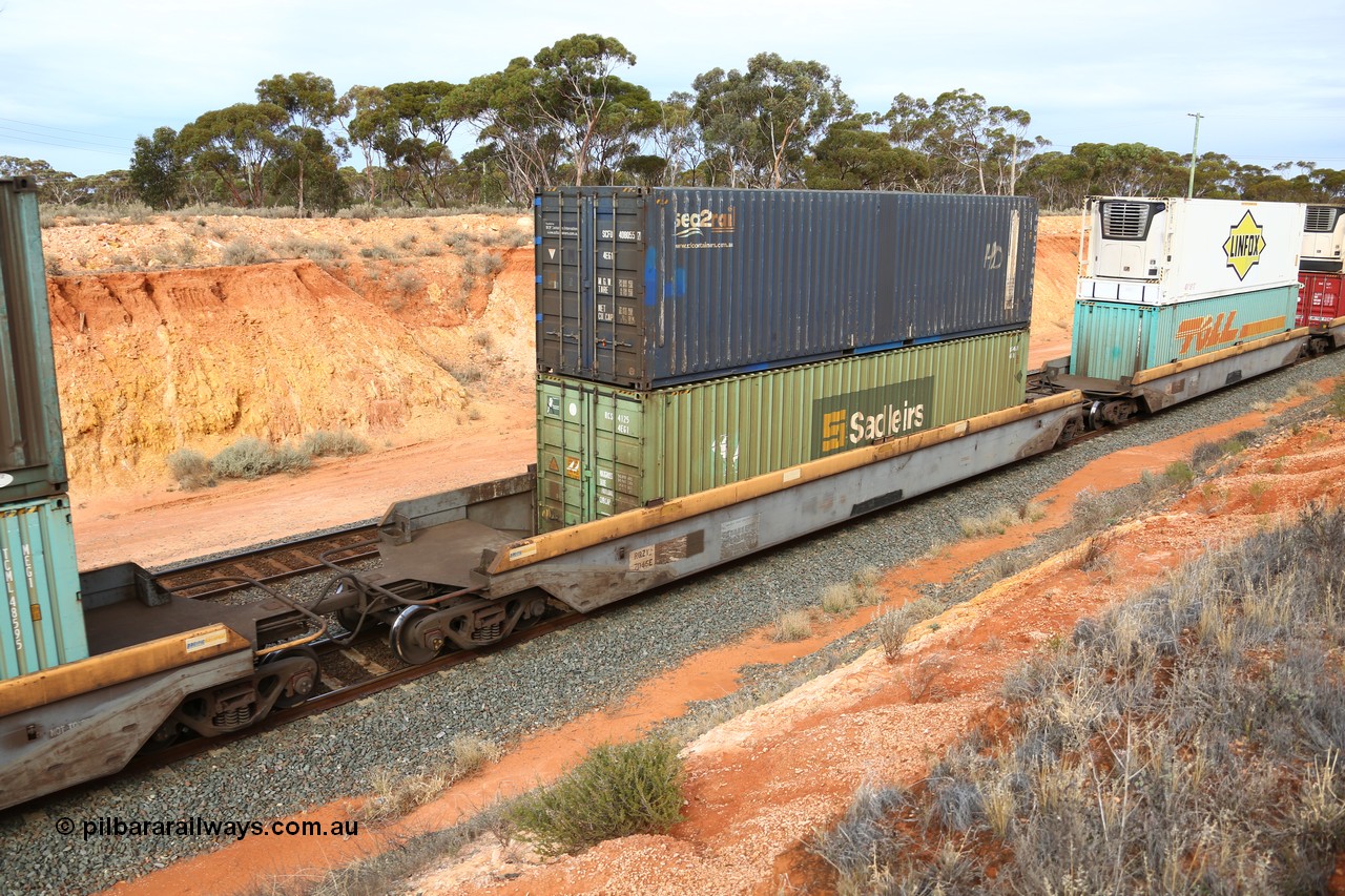 160524 3813
West Kalgoorlie, 2PM6 intermodal train, RQZY 7045 platform 4 of 5-pack well waggon set, one of thirty two sets built by Goninan NSW in 1995-96 for National Rail loaded with a Sadleirs 40' 4EG1 type container RCS 4125 double stacked with Austrans branded Sea2Rail 40' 4EG1 type container SCFU 408055 [7].
Keywords: RQZY-type;RQZY7045;Goninan-NSW;