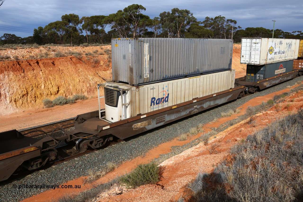 160524 3826
West Kalgoorlie, 2PM6 intermodal train, RRZY type five unit bar coupled well container waggon set RRZY 7028 platform 3, originally built by Goninan in a batch of twenty six as RQZY type for National Rail, recoded when repaired. Loaded with a RAND Refrigerated Logistics 46' MFR1 type reefer RAND 236 double stacked with an SCF 40' container SCFU 406046 [3].
Keywords: RRZY-type;RRZY7028;Goninan-NSW;RQZY7-type;