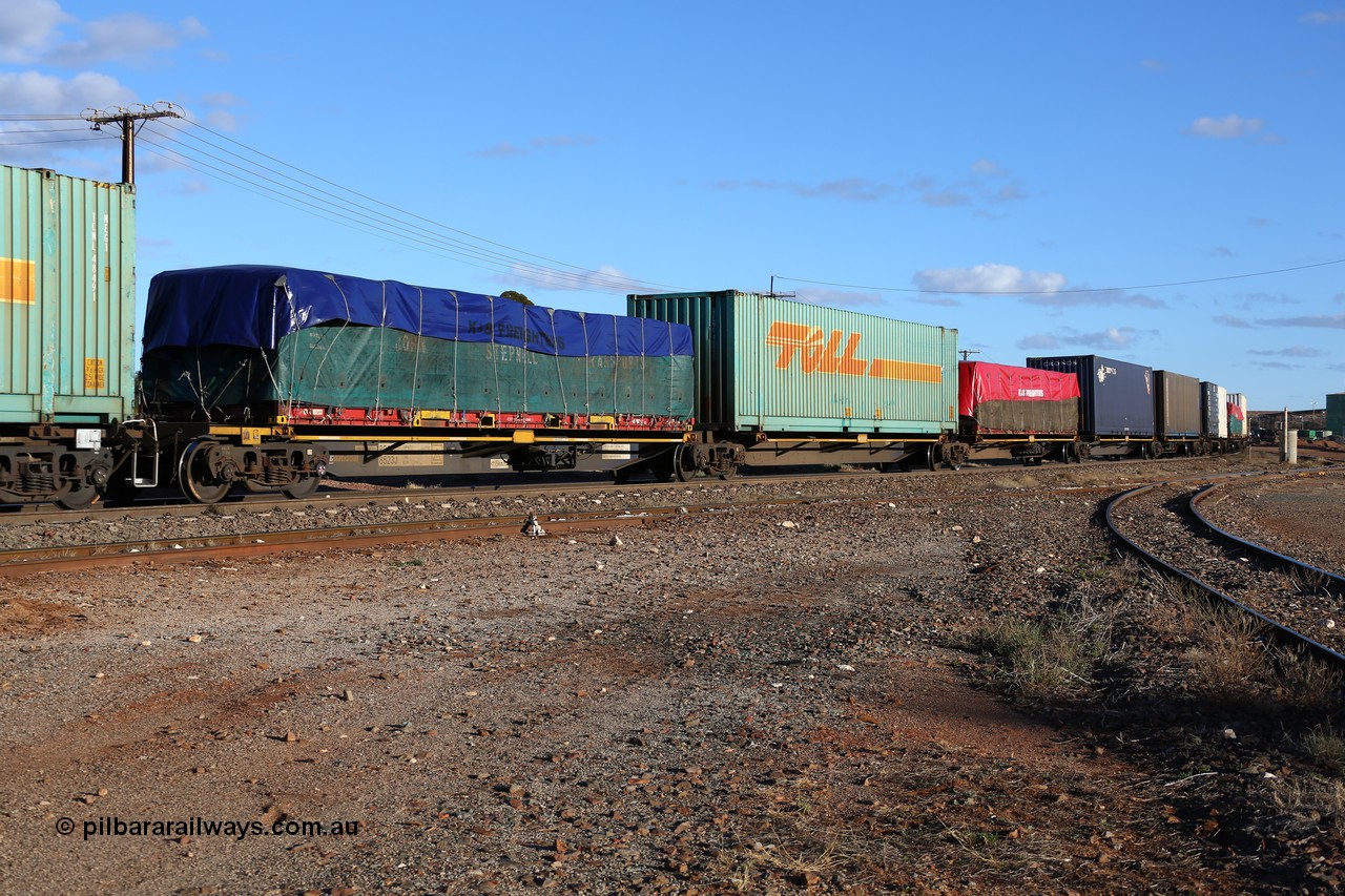 160528 8339
Parkeston, 5SP5 intermodal train, RRQY 8523 the final unit of a batch of twenty five five pack articulated waggon sets built in 2015 by Qiqihar Rollingstock Works in China. Seen here loaded with a 40' flat rack with a John Stepnell Transport tarped load, 48' Toll TCML 48533, 40' flatrack and two 40 ' containers.
Keywords: RRQY-type;RRQY8523;Qiqihar-Rollingstock-Works-China;