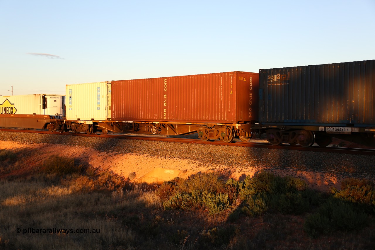 160601 10100
West Kalgoorlie, 2MP5 intermodal train, RQFY 83 container waggon, built by Victorian Railways Bendigo Workshops in 1980 as a batch of seventy five VQFX type skeletal container waggons, recoded to VQFY c1985, then RQFY May 1994, May 1995 to RQFF, then 2CM bogies fitted in Aug 1995 and current code Dec 1995.
Keywords: RQFY-type;RQFY83;Victorian-Railways-Bendigo-WS;VQFX-type;