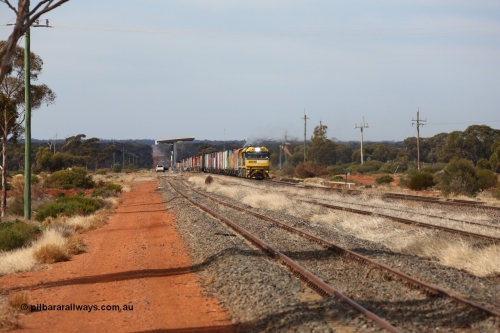 160523 2925
Parkeston, 7SP3 intermodal train, a pair of Goninan built GE model Cv40-9i NR class units NR 12 serial 7250-02/97-214 and NR 51 serial 7250-08/97-253 lead the train 'elephant style' out of the dip and along the mainline at the 1776 km. The PN local is in the car at the gantry performing a roll-by, the track on the left is the Engineers Siding.
Keywords: NR-class;NR12;Goninan;GE;Cv40-9i;7250-02/97-214;