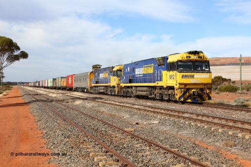 160523 2931
Parkeston, 7SP3 intermodal train, a pair of Goninan built GE model Cv40-9i NR class units NR 12 serial 7250-02/97-214 and NR 51 serial 7250-08/97-253 lead the train 'elephant style' out of the dip and along the mainline at the 1776 km. The PN local is in the car at the gantry performing a roll-by, the track on the left is the Engineers Siding.
Keywords: NR-class;NR12;Goninan;GE;Cv40-9i;7250-02/97-214;