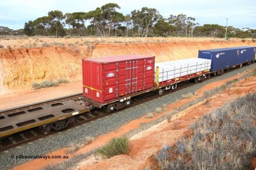 160524 3808
West Kalgoorlie, 2PM6 intermodal train, RQFY 73 container waggon, built by Victorian Railways Bendigo Workshops in 1980 as a batch of seventy five VQFX type skeletal container waggons, recoded to VQFY c1985, then RQFF May 1994, then 2CM bogies fitted in Aug 1995 and current code Jan 1996. Loaded with a Cahill Transport 20' 2FG4 type side door container CHLL 200023[7] and a K&S 40' flatrack KHS 400807 with Wesbeam products.
Keywords: RQFY-type;RQFY73;Victorian-Railways-Bendigo-WS;VQFX-type;