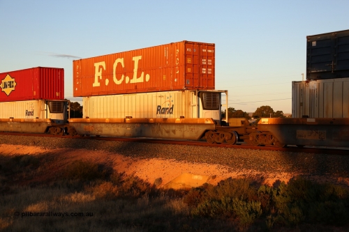 160601 10113
West Kalgoorlie, 2MP5 intermodal train, RQZY 7065 platform 3 of 5-pack well waggon set one of thirty two waggon sets built by Goninan NSW for National Rail in 1995-96, double stacked with an FCL 48' box 910803[7] and Rand Refrigerated Logistics 46' 6
