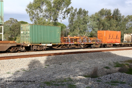 160609 0455
Woodbridge, 5PM5 intermodal train, RQFY 83 container waggon, built by Victorian Railways Bendigo Workshops in 1980 as a batch of seventy five VQFX type skeletal container waggons, recoded to VQFY c1985, then RQFY May 1994, May 1995 to RQFF, then 2CM bogies fitted in Aug 1995 and current code Dec 1995., loaded with Royal Wolf 20' box TRDU 723923 and a 40' flatrack KT 161 loaded with timber beams.
Keywords: RQFY-type;RQFY83;Victorian-Railways-Bendigo-WS;VQFX-type;