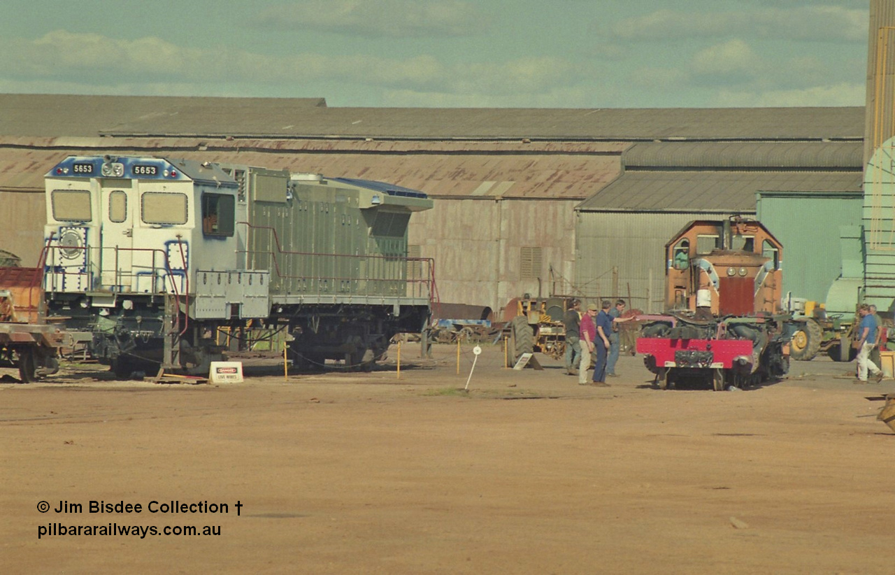16941
Bassendean, Goninan GE CM40-8M rebuild unit for BHP Iron Ore 5653 'Chiba' serial 8412-10 / 93-144 sits out the back on shop bogies still under construction in the October 1993 image as the Goninan shunt loco moves the frame of a steam engine. 5653 was rebuilt from Mt Newman Mining AE Goodwin built ALCo M636 5484 serial G6061-5.
Jim Bisdee photo.
Keywords: 5653;Goninan;GE;CM40-8M;8412-10/93-144;rebuild;AE-Goodwin;ALCo;M636C;5484;G6061-5;