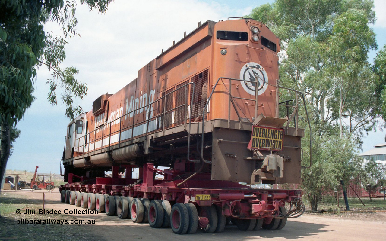 20860
Bassendean, Goninan workshops, sitting outside the locked gates having just been bought down from Port Hedland, Mt Newman Mining's AE Goodwin ALCo C636 unit 5454 serial G6012-3 on a ninety six wheel road float. 5454 will be rebuilt into CM40-8M unit 5641 by June 1992. Image taken January 1992.
Jim Bisdee photo.
Keywords: 5454;AE-Goodwin;ALCo;C636;G6012-3;