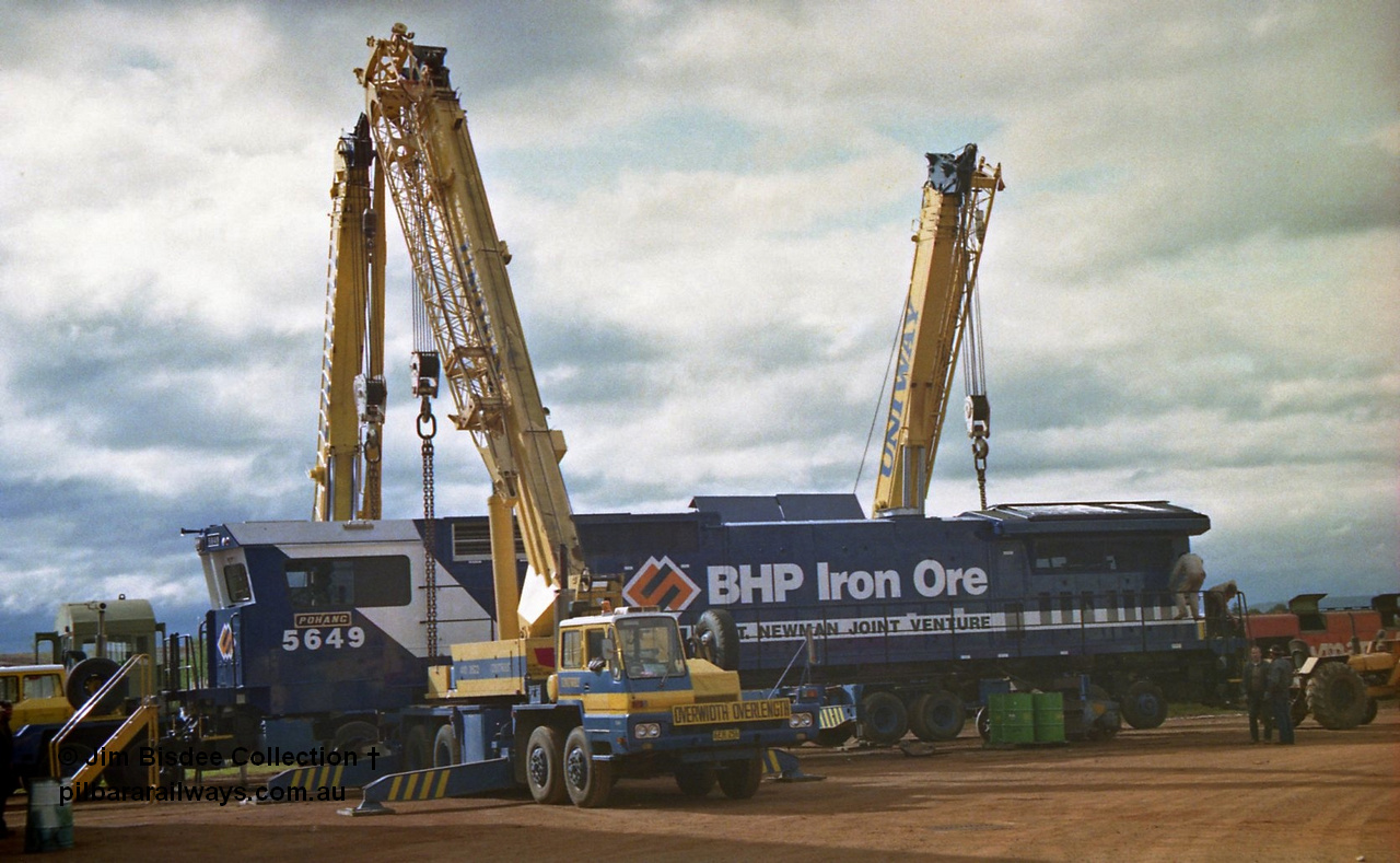 23882
Bassendean, Goninan workshops, BHP Iron Ore GE CM40-8M rebuild unit 5649 'Pohang' serial 8412-07 / 93-140 is being lifted up and prepped for road haulage to Port Hedland. 5649 was rebuilt from AE Goodwin ALCo M636 unit 5473 serial G6047-5. July 1993.
Jim Bisdee photo.
Keywords: 5649;Goninan;GE;CM40-8M;8412-07/93-140;rebuild;AE-Goodwin;ALCo;M636C;5473;G6047-5;