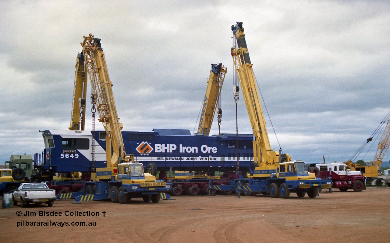 23885
Bassendean, Goninan workshops, BHP Iron Ore GE CM40-8M rebuild unit 5649 'Pohang' serial 8412-07 / 93-140 is lifted up with the Bell road transport float being prepped underneath for road haulage to Port Hedland. 5649 was rebuilt from AE Goodwin ALCo M636 unit 5473 serial G6047-5. July 1993.
Jim Bisdee photo.
Keywords: 5649;Goninan;GE;CM40-8M;8412-07/93-140;rebuild;AE-Goodwin;ALCo;M636C;5473;G6047-5;